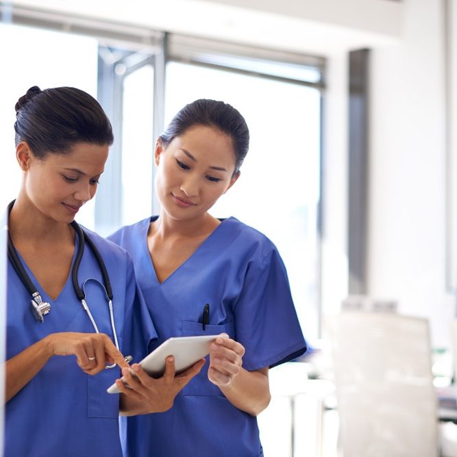 reviewing-patient-data-shot-two-female-nurses-using-tablet-review-medical-records
